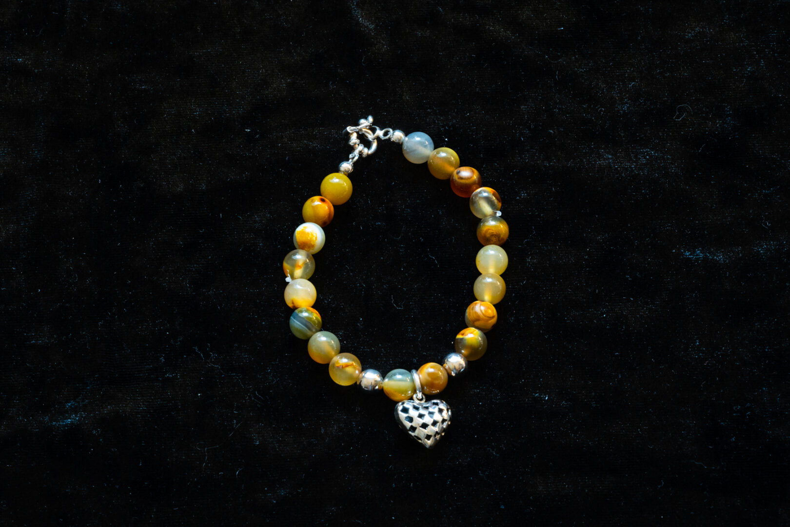 A Yellow Beaded Bracelet with Silver Heart