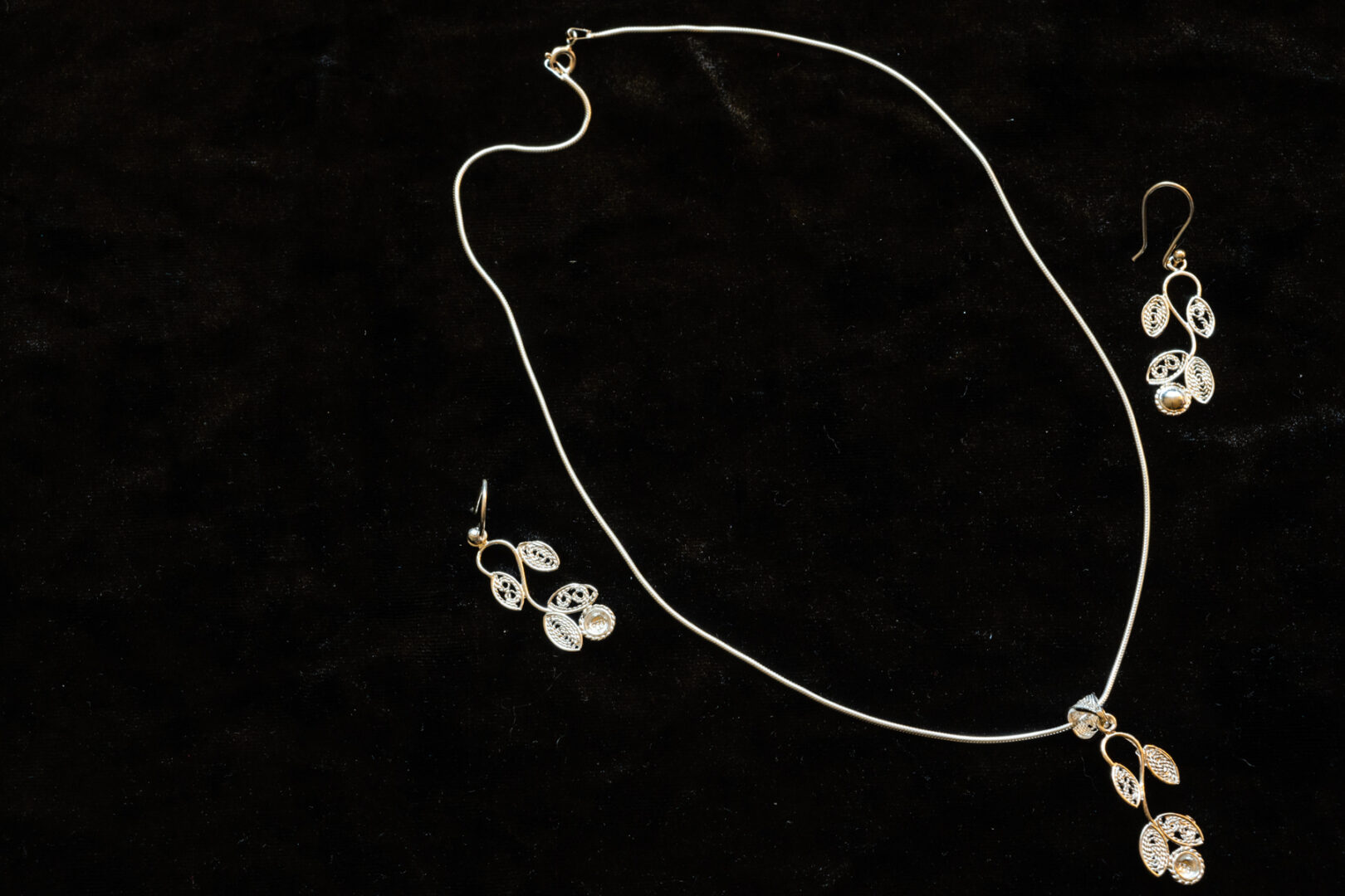 A picture of a jewelry set with locket and earrings