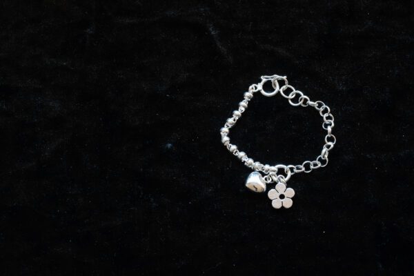 A picture of a bracelet with heart and flower